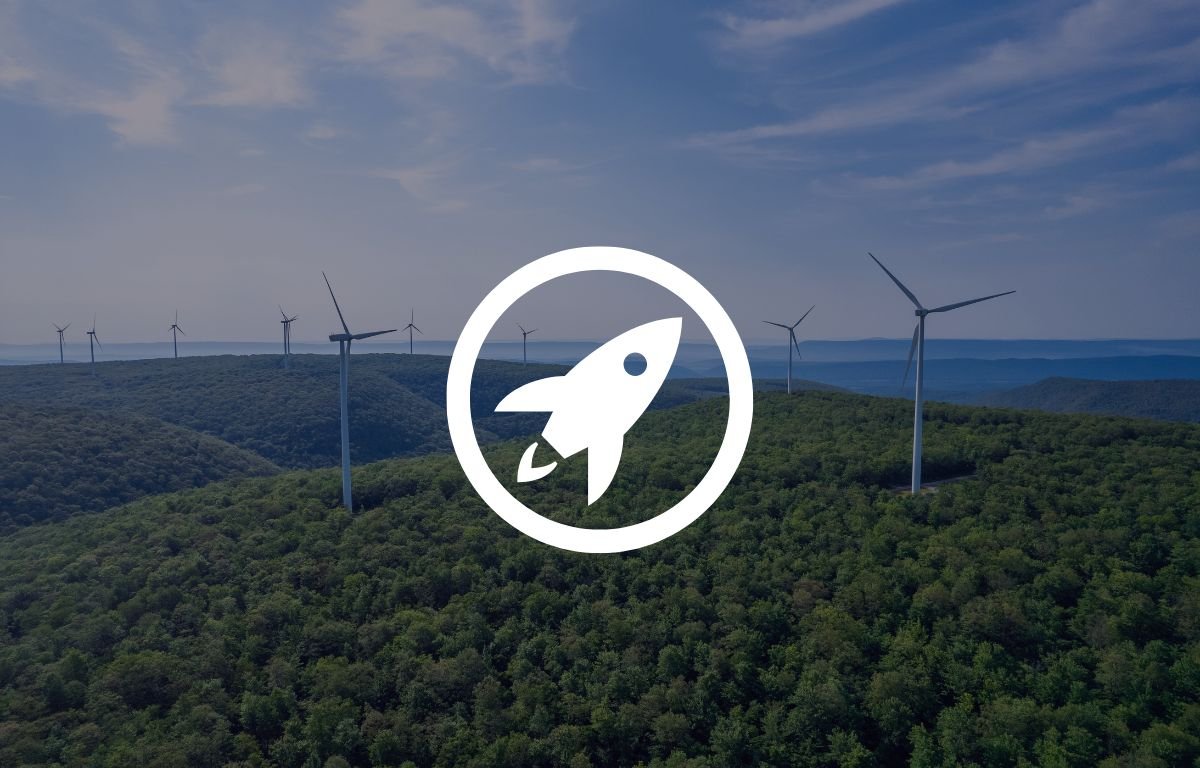 Wind turbines on a forested hillside under a blue sky, with a white rocket icon in a circle superimposed in the center. Designed by Circular Design, a not-for-profit web design agency.